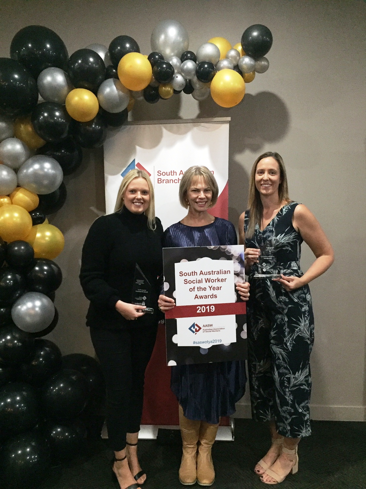 Emma Drummond (left) and Tara Blaikie (right), pictured with colleague Julie Powell (centre) at the South Australian Social Worker of the Year Awards night last week.
