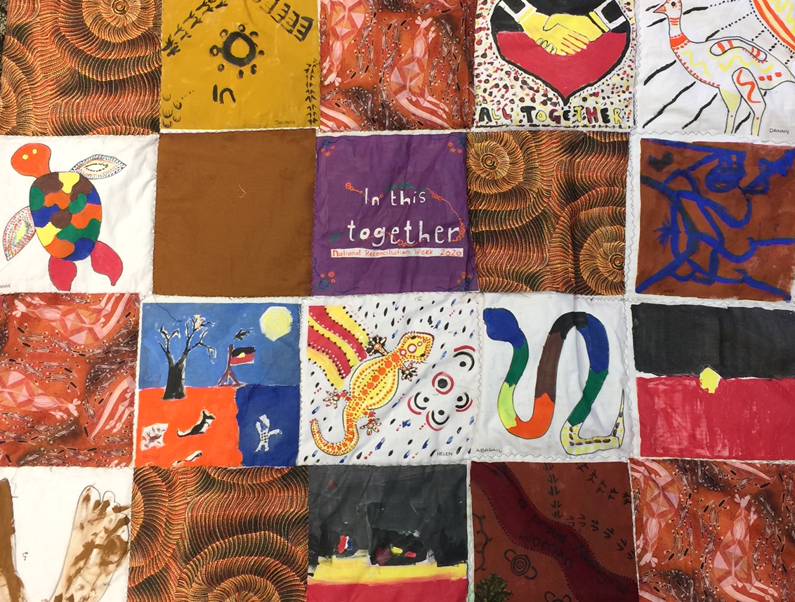 Quilt made of 20 square panels sewn together Each panel is painted by a young person representing an element of Aboriginal history or culture. Includes a colourful turtle, Aboriginal flag, rainbow serpent and emu.